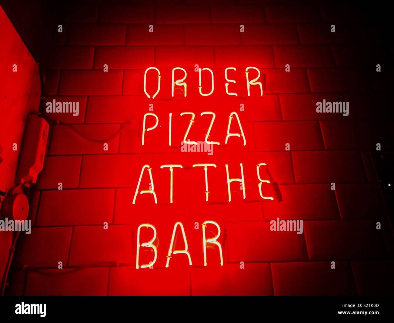 Order pizza neon sign. Bar food. Pizza. Fast food - Smartphone Captured Stock Image