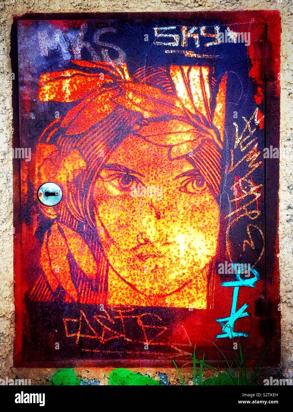 Art and graffiti adorn a utility cabinet, perhaps for gas or electricity. Stock Photo