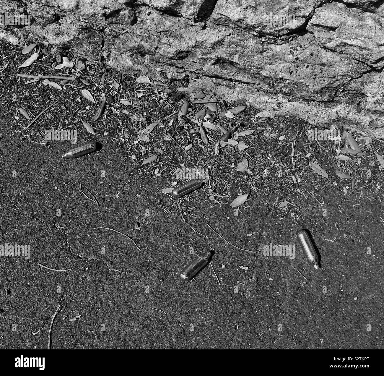 Discarded nitrous oxide canisters on a pavement in Weston-super-Mare, UK - Smartphone Captured Stock Image