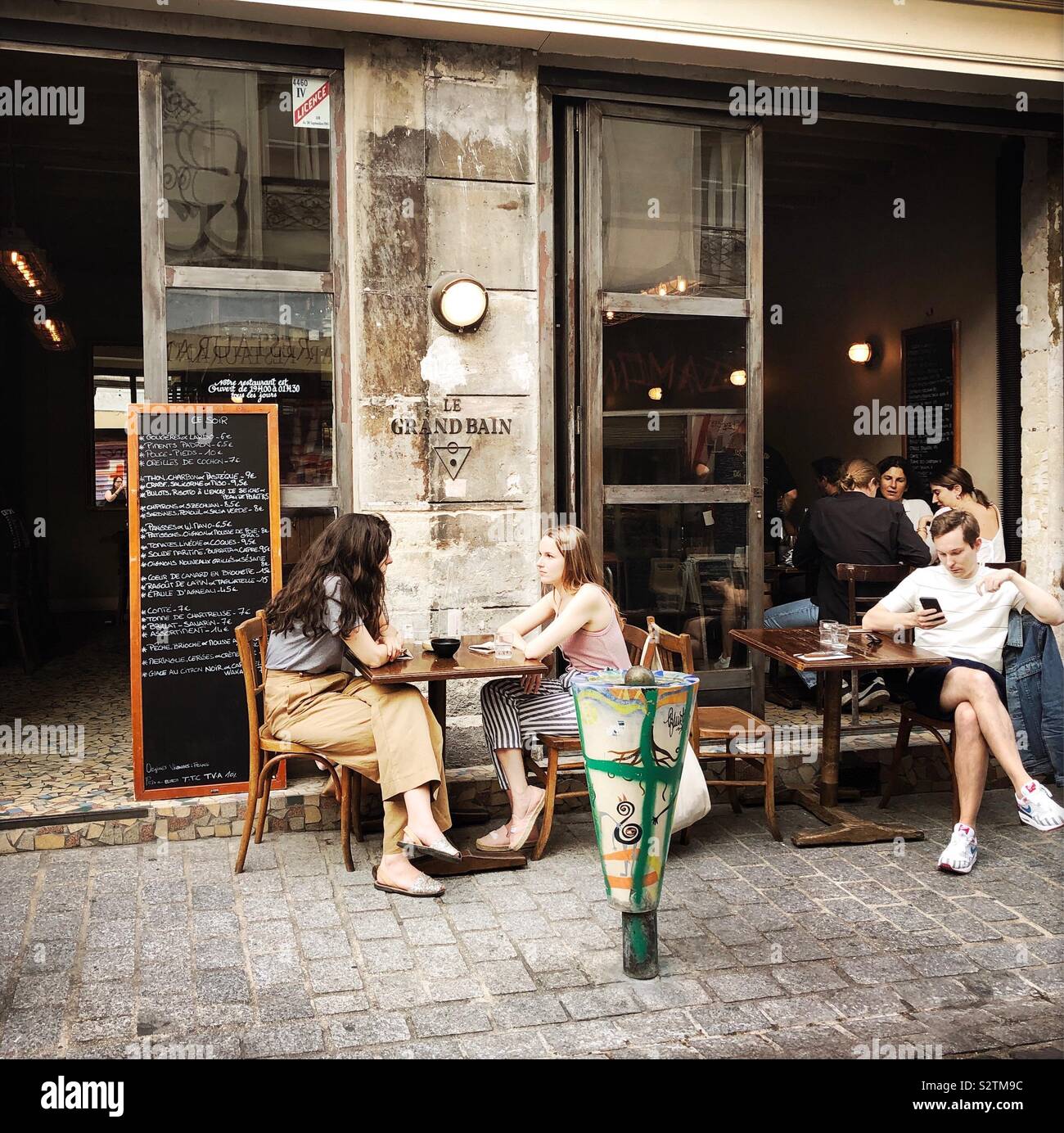 People sitting outside Le Grand Bain, Bellville, Paris, France Stock Photo