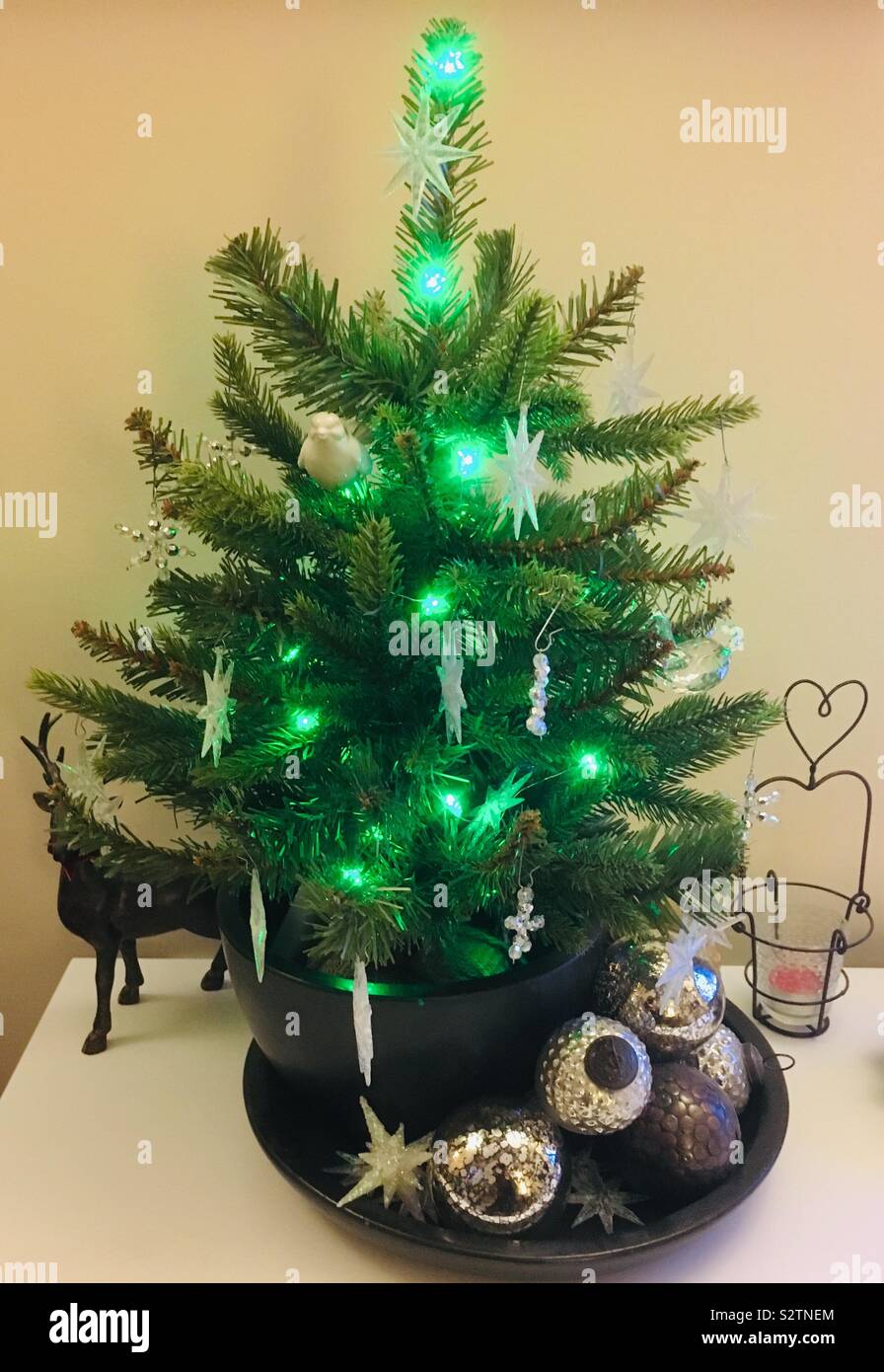 Small artificial Christmas tree with ornaments Stock Photo Alamy