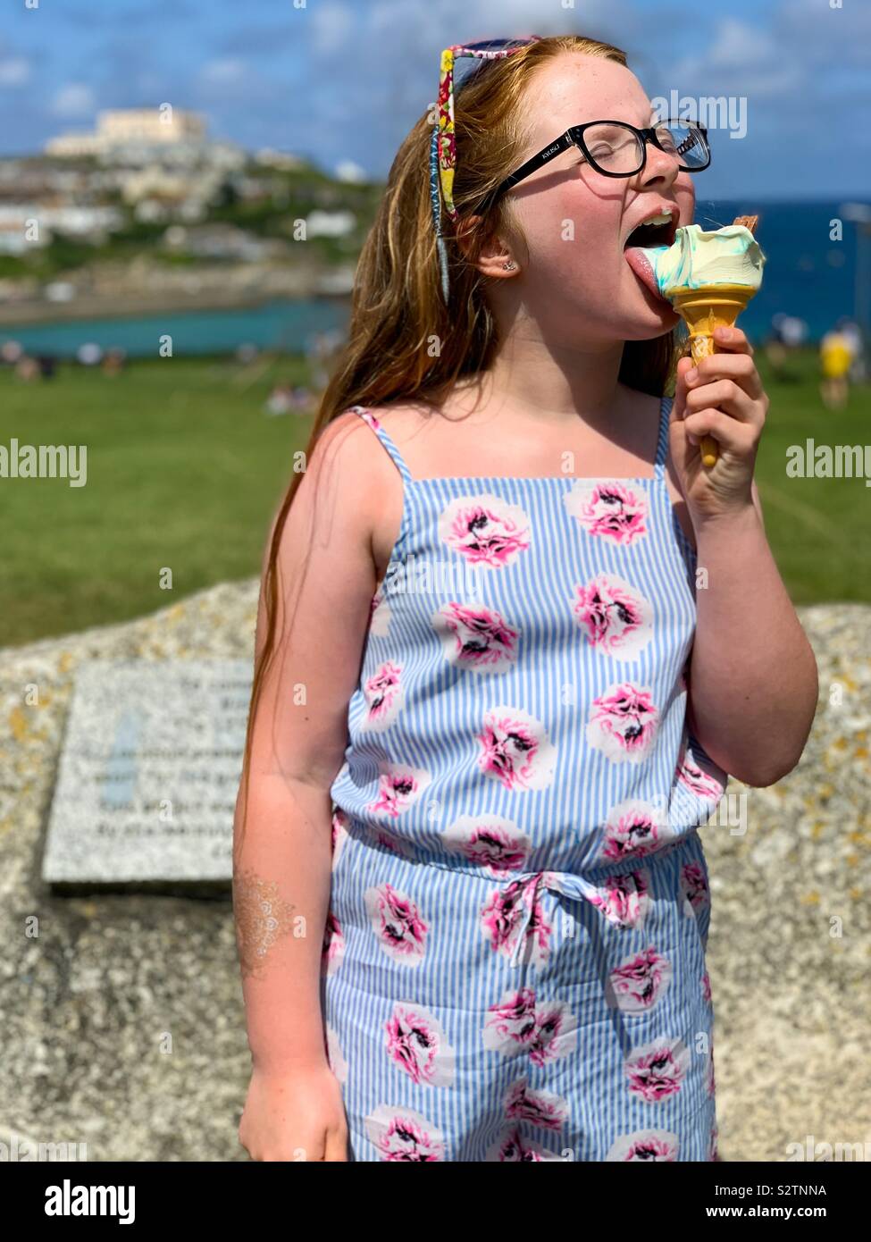 Young girl eating ice cream in Newquay Cornwall Stock Photo