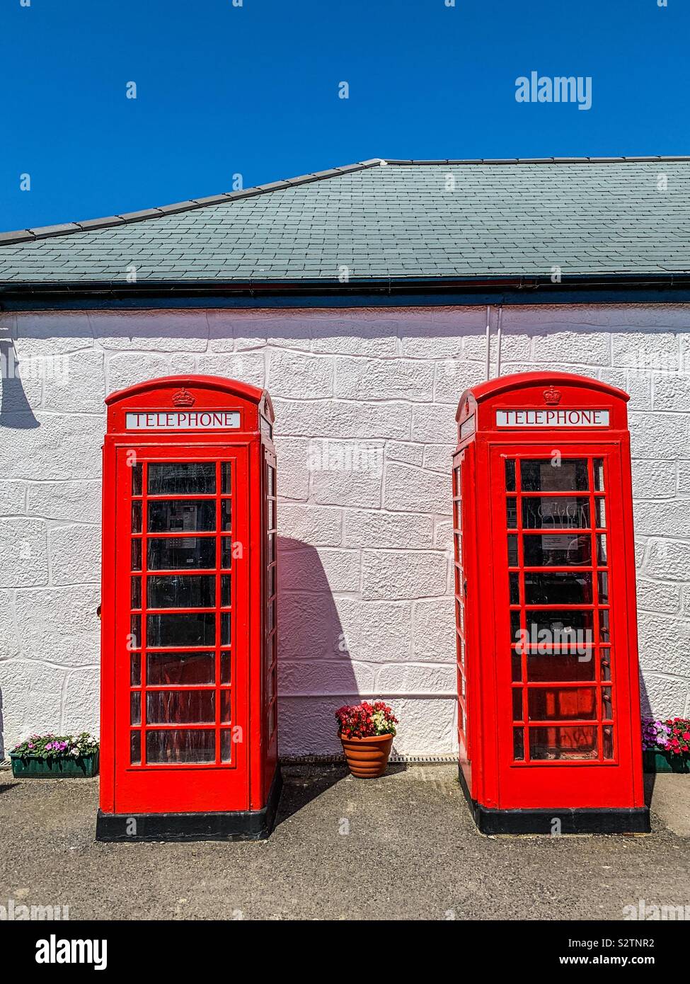 Two red telephone boxes at Land’s end Cornwall uk - Smartphone Captured Stock Image