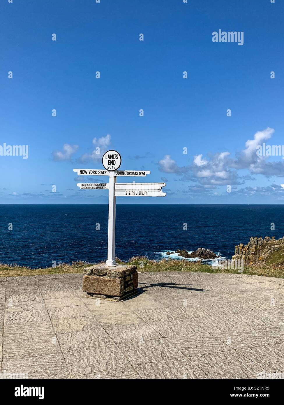 The iconic Land’s End distance sign in Cornwall - Smartphone Captured Stock Image