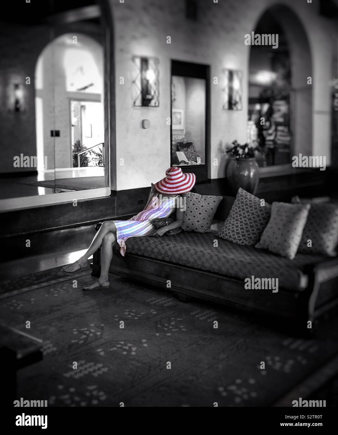 A tired woman tourist asleep in a hotel lobby - Smartphone Captured Stock Image