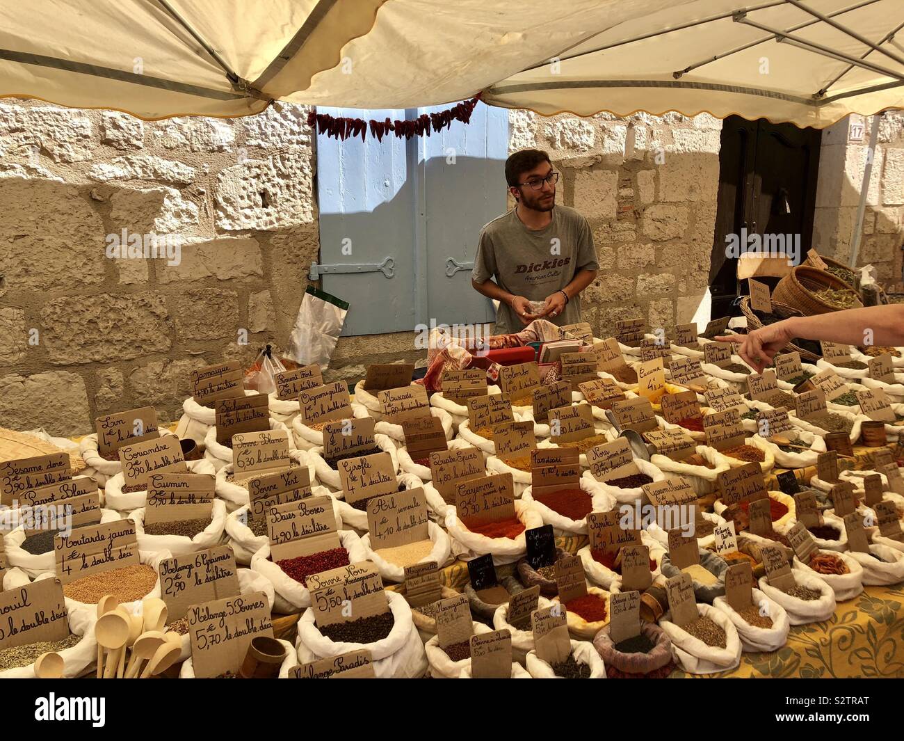 Man selling herbs and spices in a French market - Smartphone Captured Stock Image
