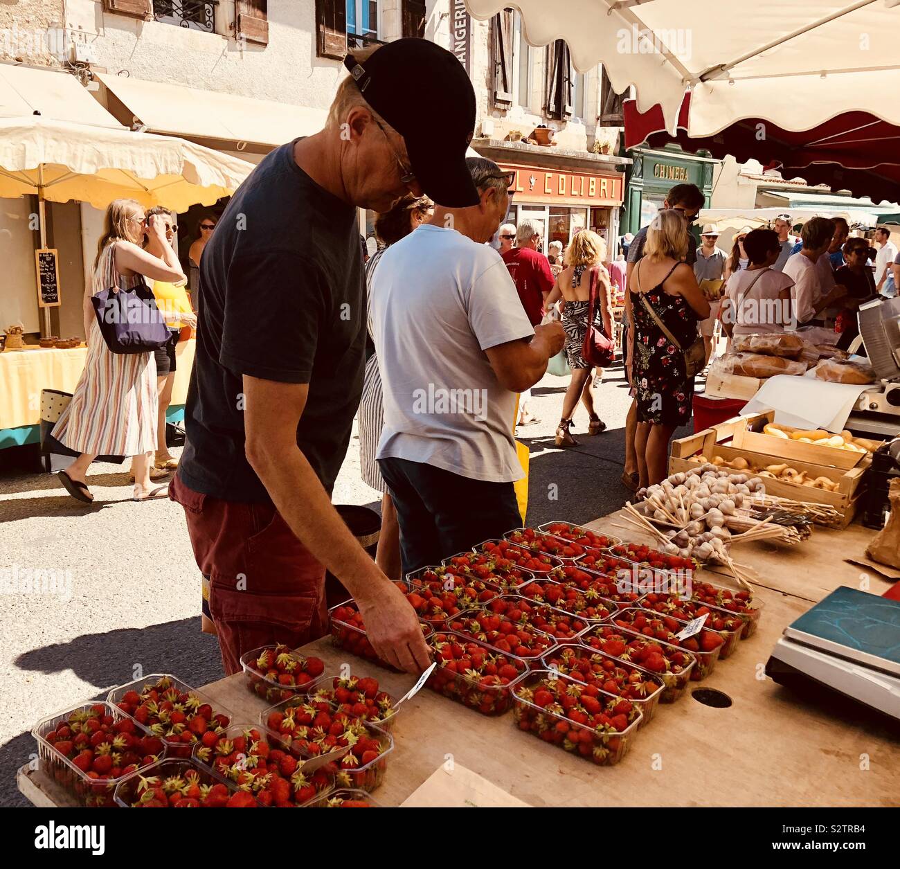Buying strawberries in a French market Stock Photo Alamy