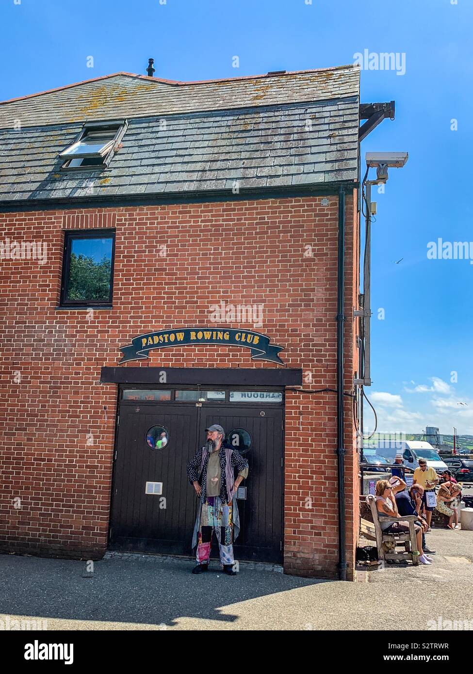 Eccentric man stood outside Padstow rowing club Stock Photo