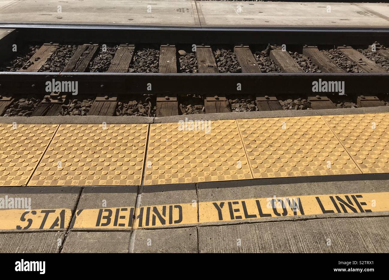Stand behind yellow line Stock Photo Alamy