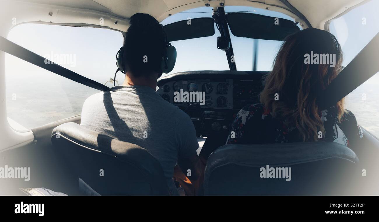 Pilot and passenger in light aircraft Stock Photo - Alamy