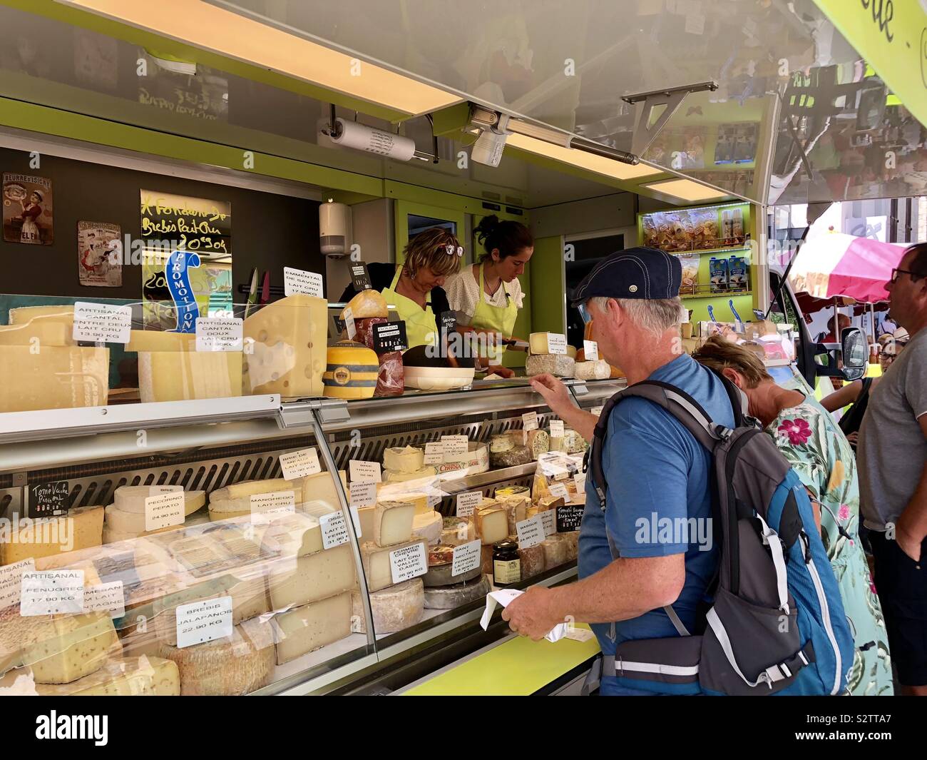 Tourist buying cheese in a French market - Smartphone Captured Stock Image