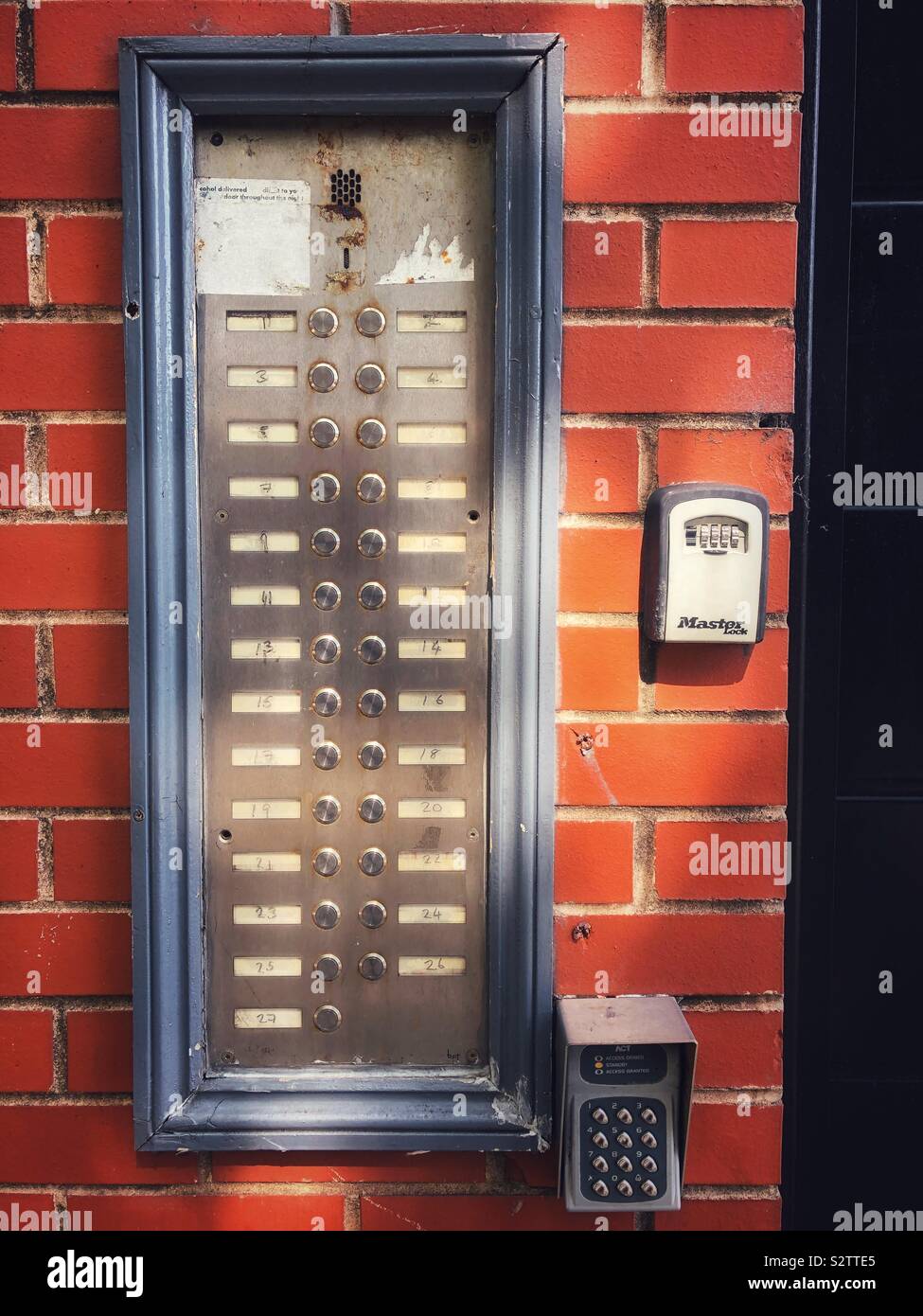 Key pad to a block of flats with dappled sunlight. - Smartphone Captured Stock Image
