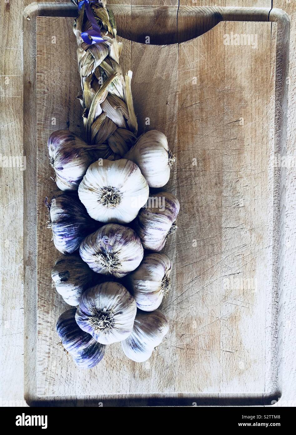 Bunch of garlic on wooden board - Smartphone Captured Stock Image