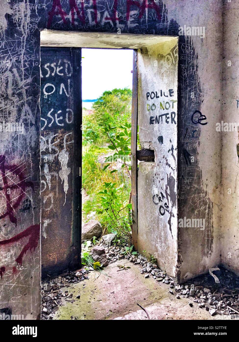 Graffitied doorway in abandoned outbuilding - Smartphone Captured Stock Image