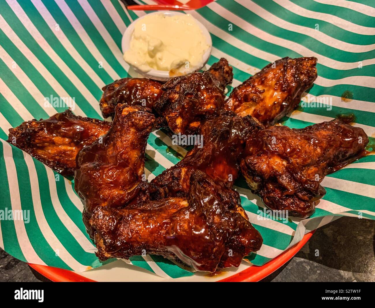Bowl of bbq chicken wings and cream sauce Stock Photo