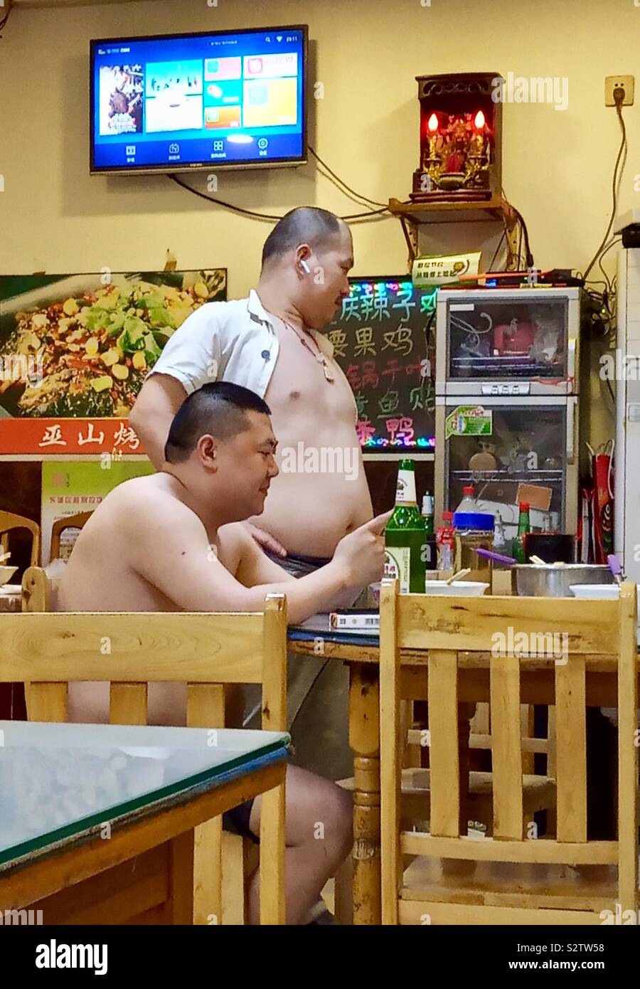 Chinese men in a local restaurant in Beijing. - Smartphone Captured Stock Image