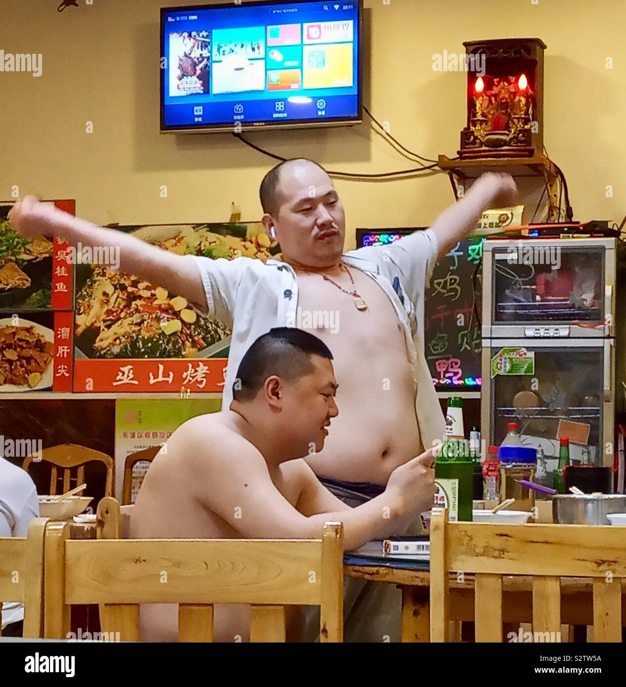 Chinese men in a local restaurant in Beijing. - Smartphone Captured Stock Image
