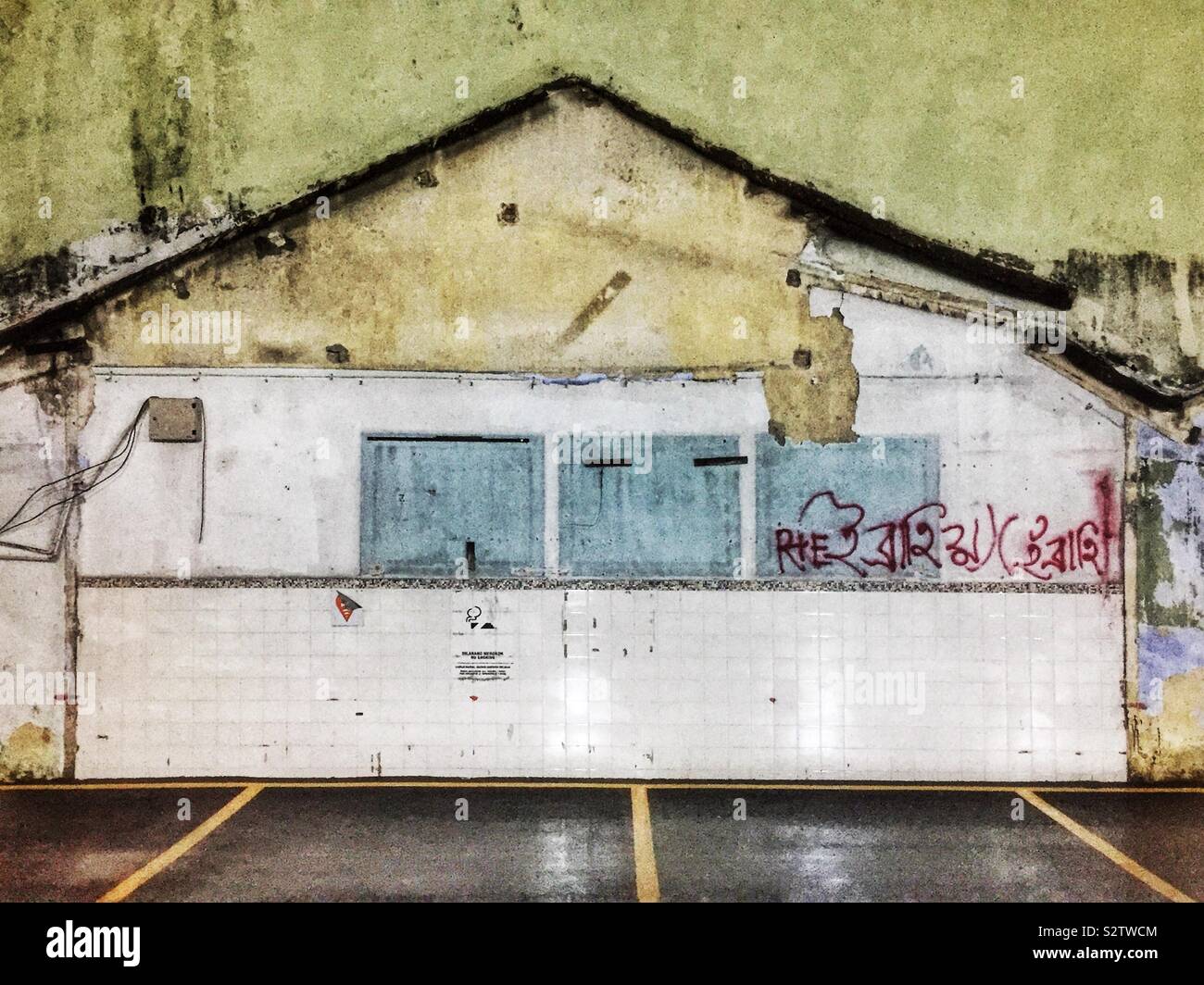 Outlines of houses and rooms remaining on the wall of a factory building after demolition, George Town, Penang, Malaysia - Smartphone Captured Stock Image