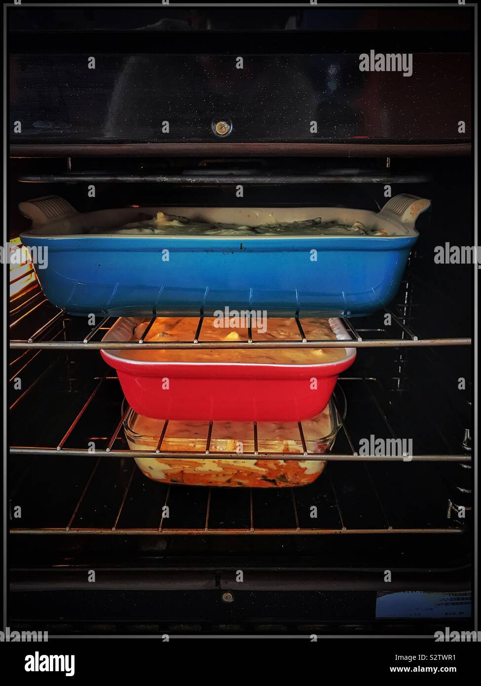Casseroles in oven. Stock Photo