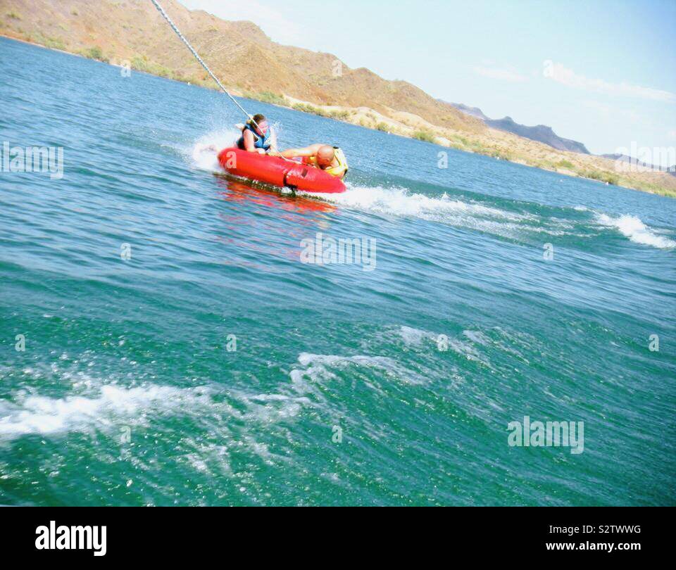 Tubing behind a boat Stock Photo Alamy