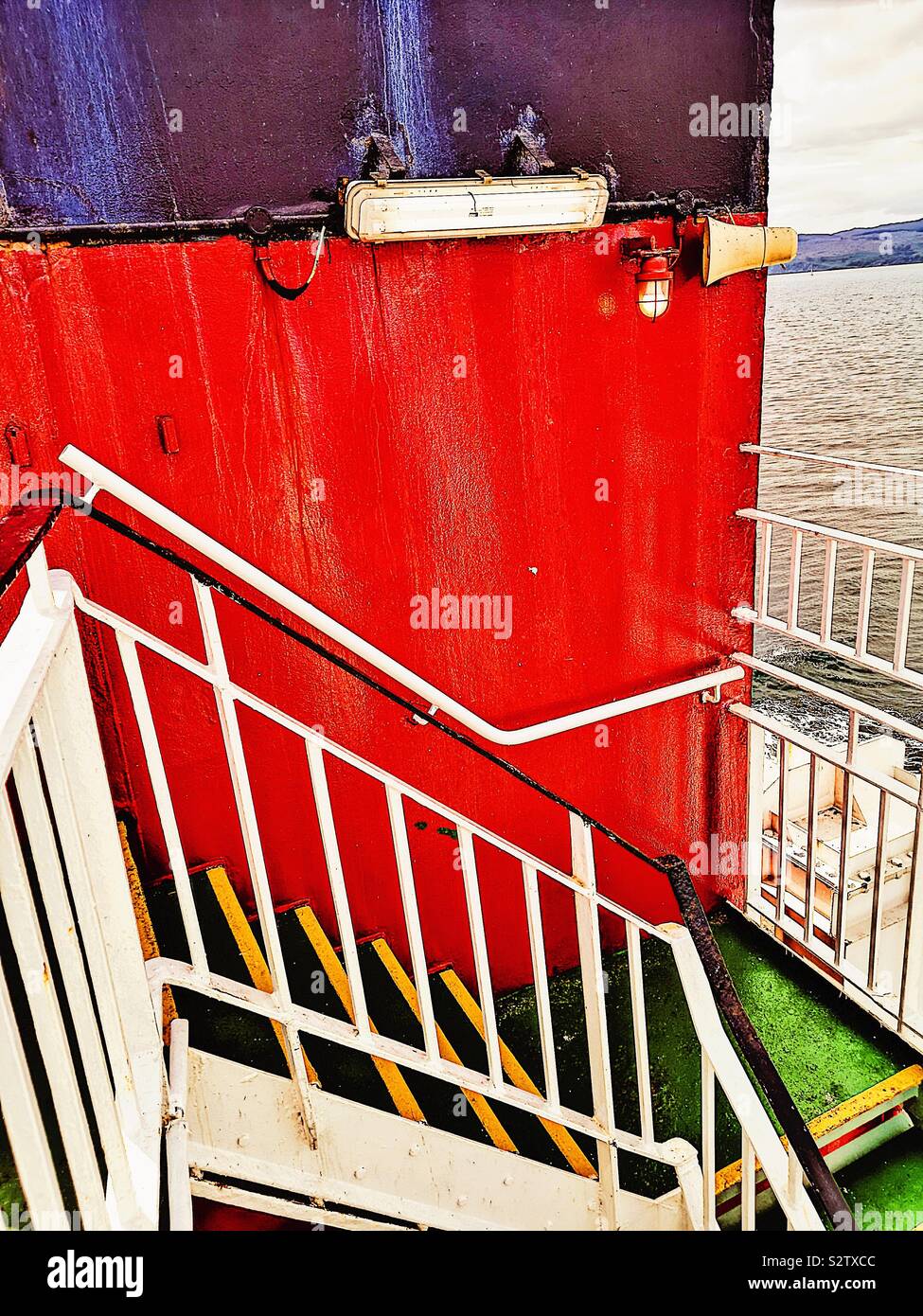 Red funnel and steps between decks on moving ship - Smartphone Captured Stock Image