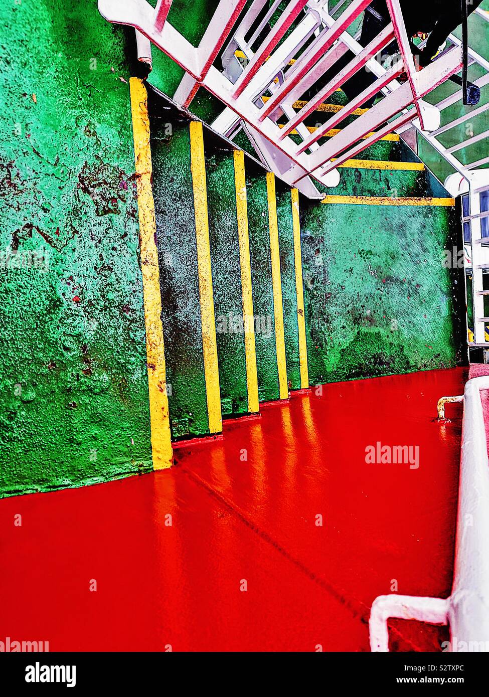 Green and yellow steps between ferry decks - Smartphone Captured Stock Image