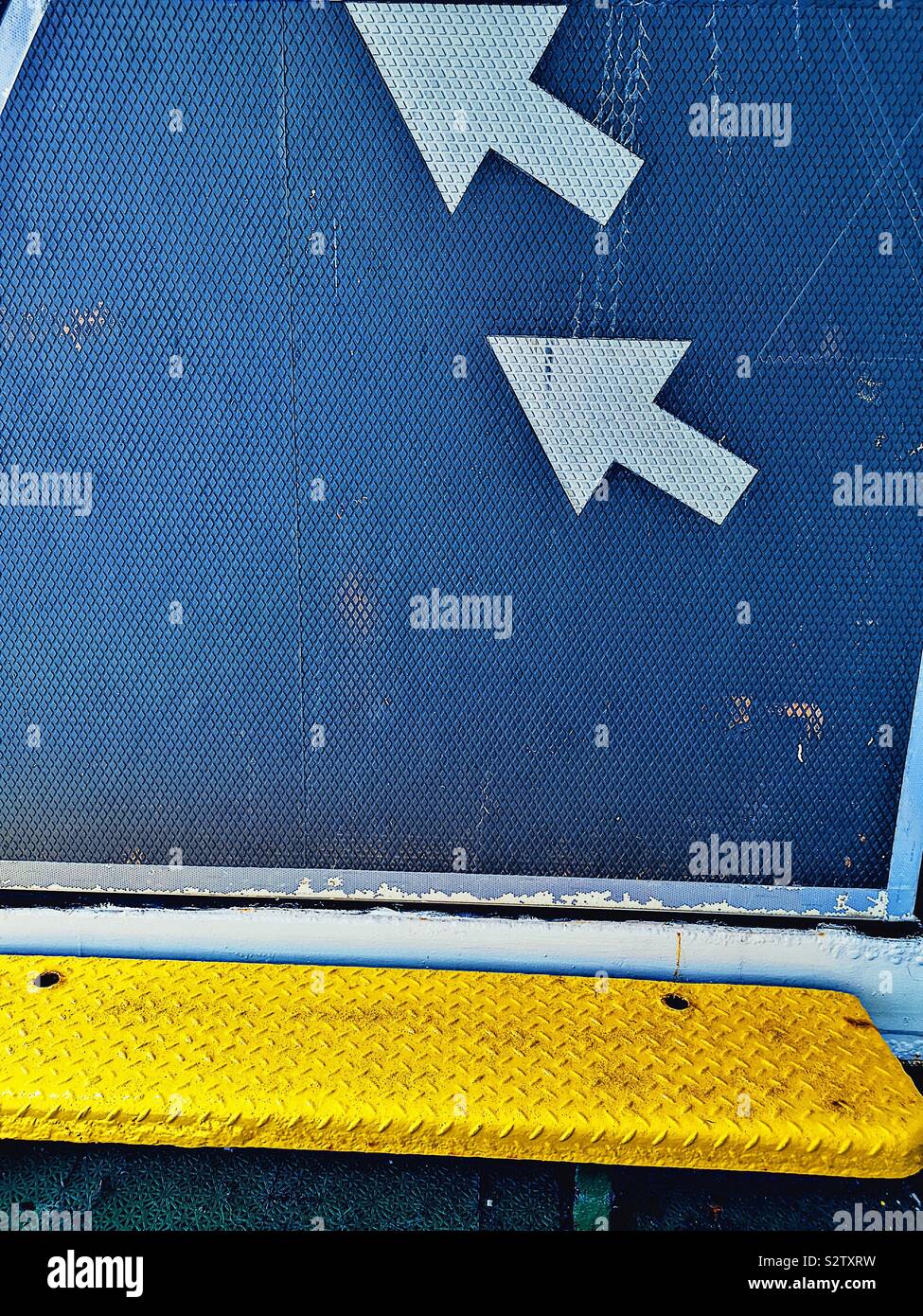 Up arrows and yellow metal textured seat - Smartphone Captured Stock Image