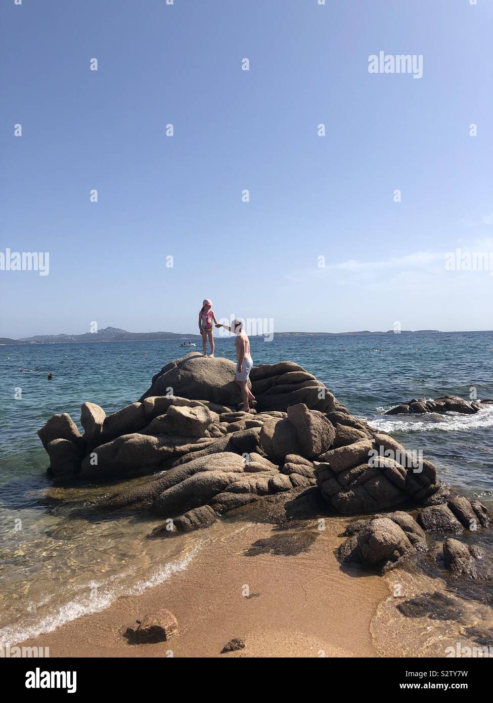 Little girl and father on beach in Sardinia Stock Photo