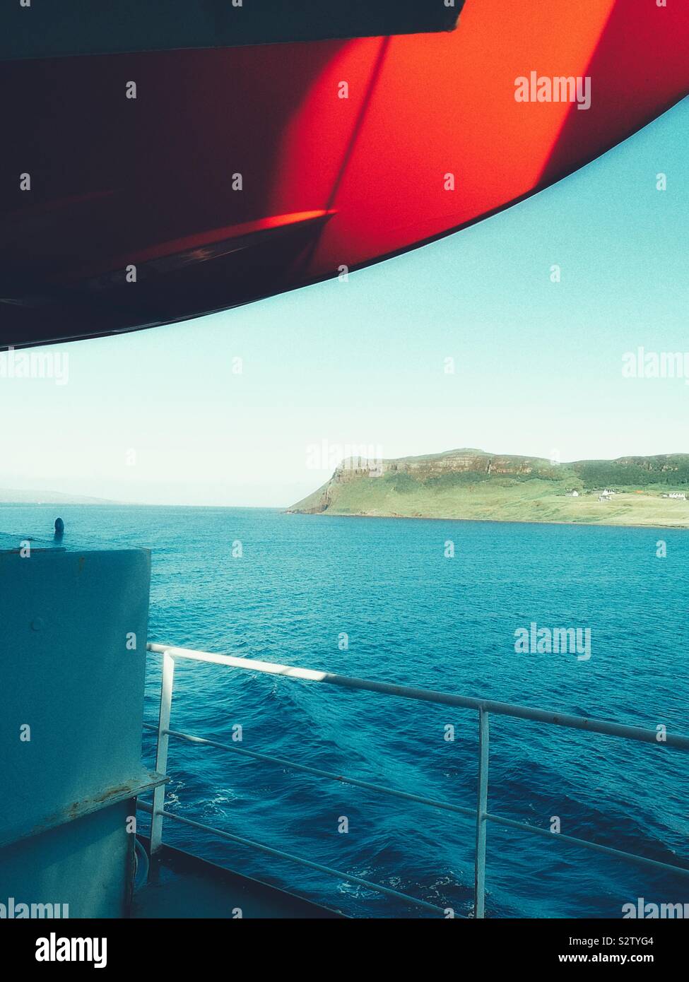 View from ferry deck beneath orange lifeboat towards the Trotternish Peninsula, Isle of Skye, Inner Hebrides, Scotland - Smartphone Captured Stock Image