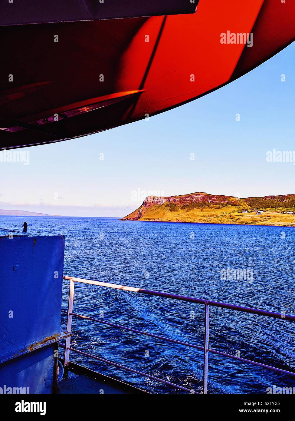 View from ferry deck beneath orange lifeboat looking towards Trotternish Peninsula, Isle of Skye, Inner Hebrides, Scotland - Smartphone Captured Stock Image
