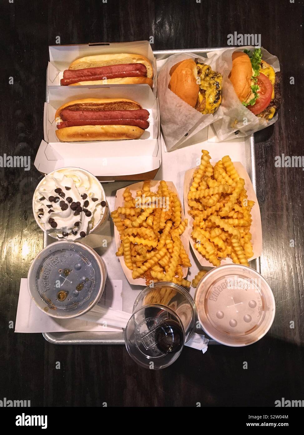 Shake Shack meal with burgers  hot dogs, milkshakes and fries - Smartphone Captured Stock Image