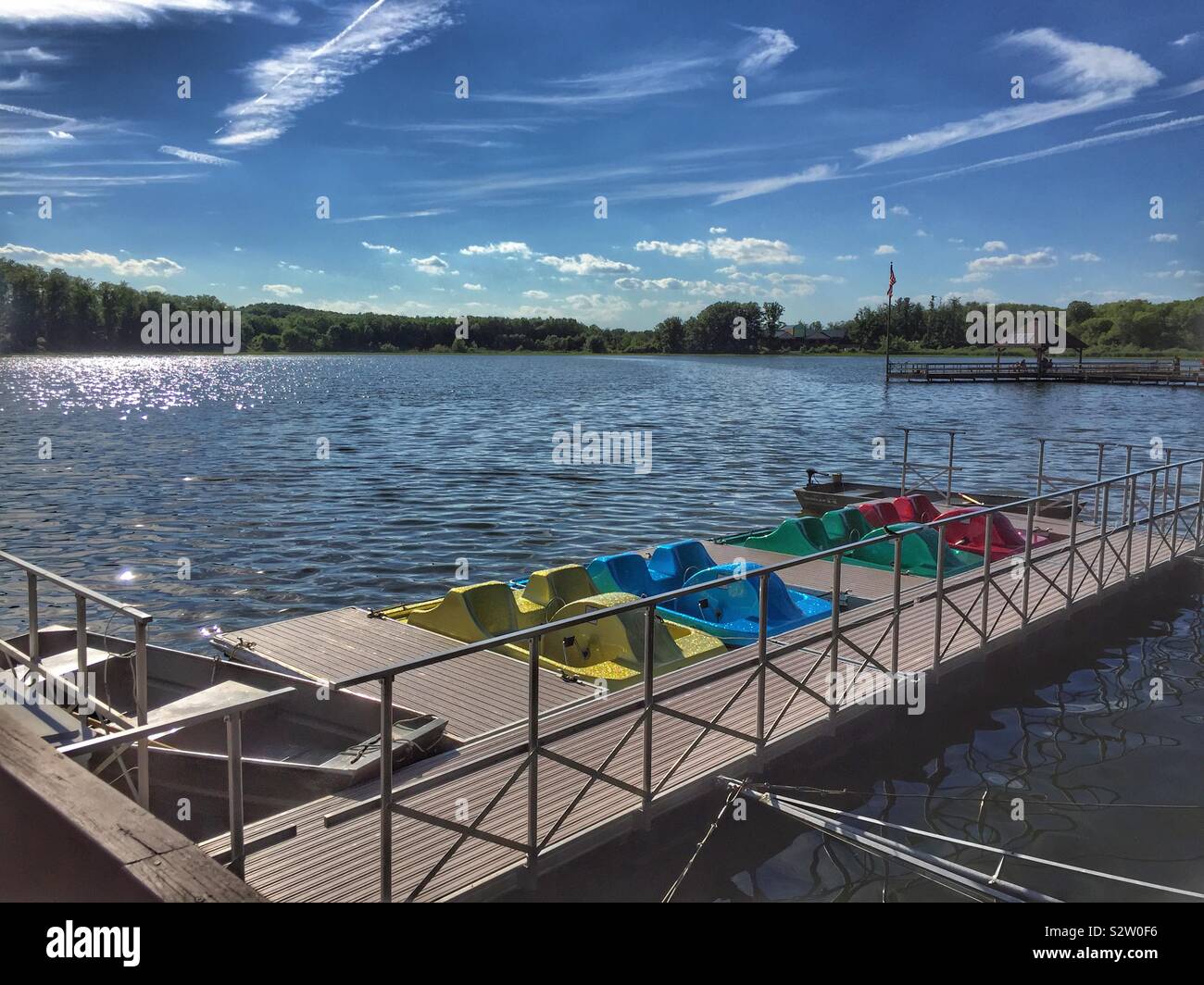 Colorful paddle boats docked at Sippo Lake on a sunny summer day - Smartphone Captured Stock Image