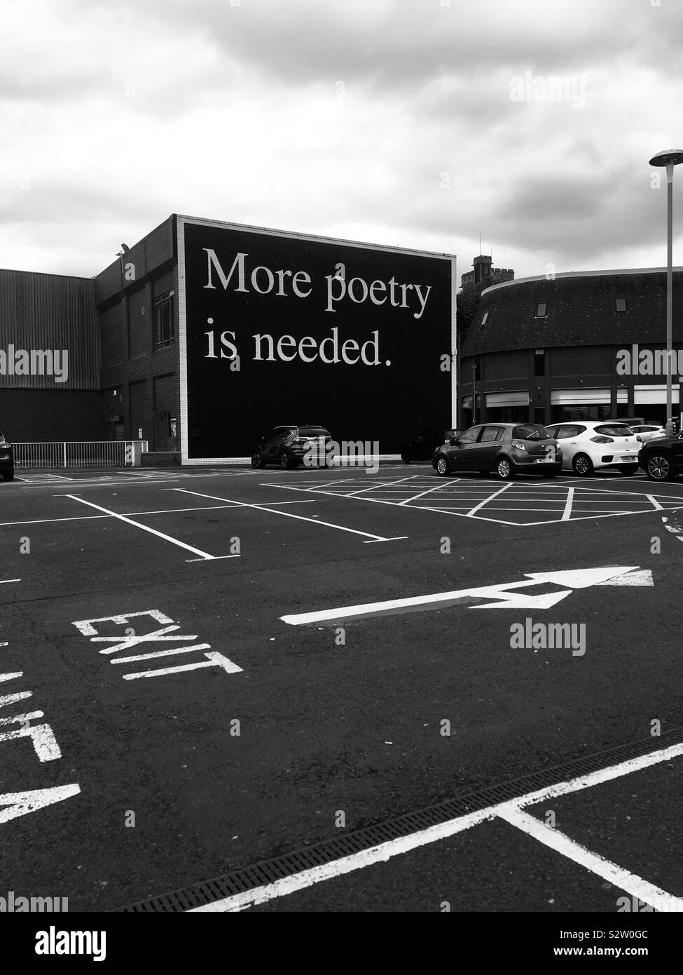 Poetry quote on a billboard in a miserable car park in Swansea - Smartphone Captured Stock Image