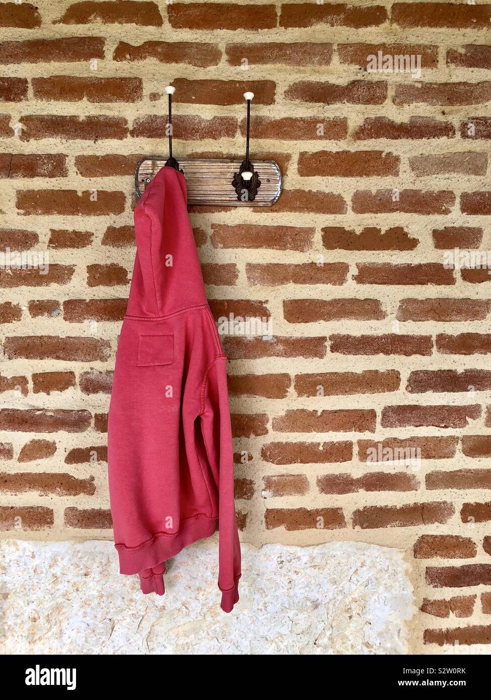 Pink hoody hanging on a hook - Smartphone Captured Stock Image