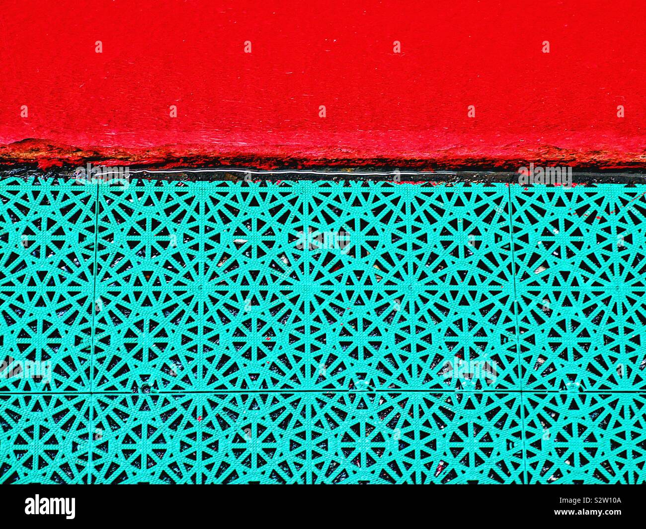 Vibrant red and repetitive green pattern contrast - Smartphone Captured Stock Image