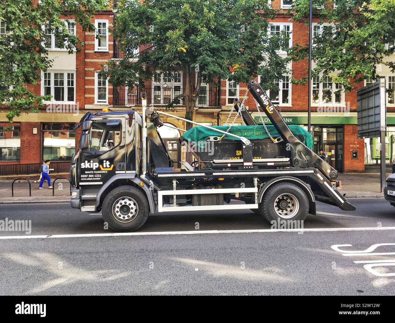 Skip truck, Kings Cross, London, England, United Kingdom. - Smartphone Captured Stock Image
