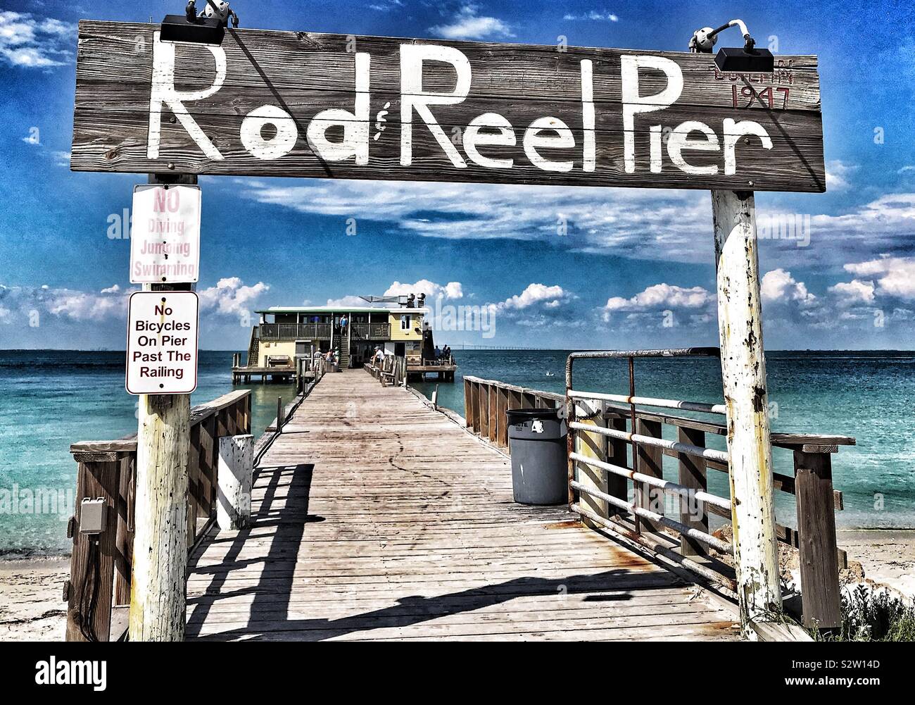 Fishing rod, spinning reel on the background pier river bank