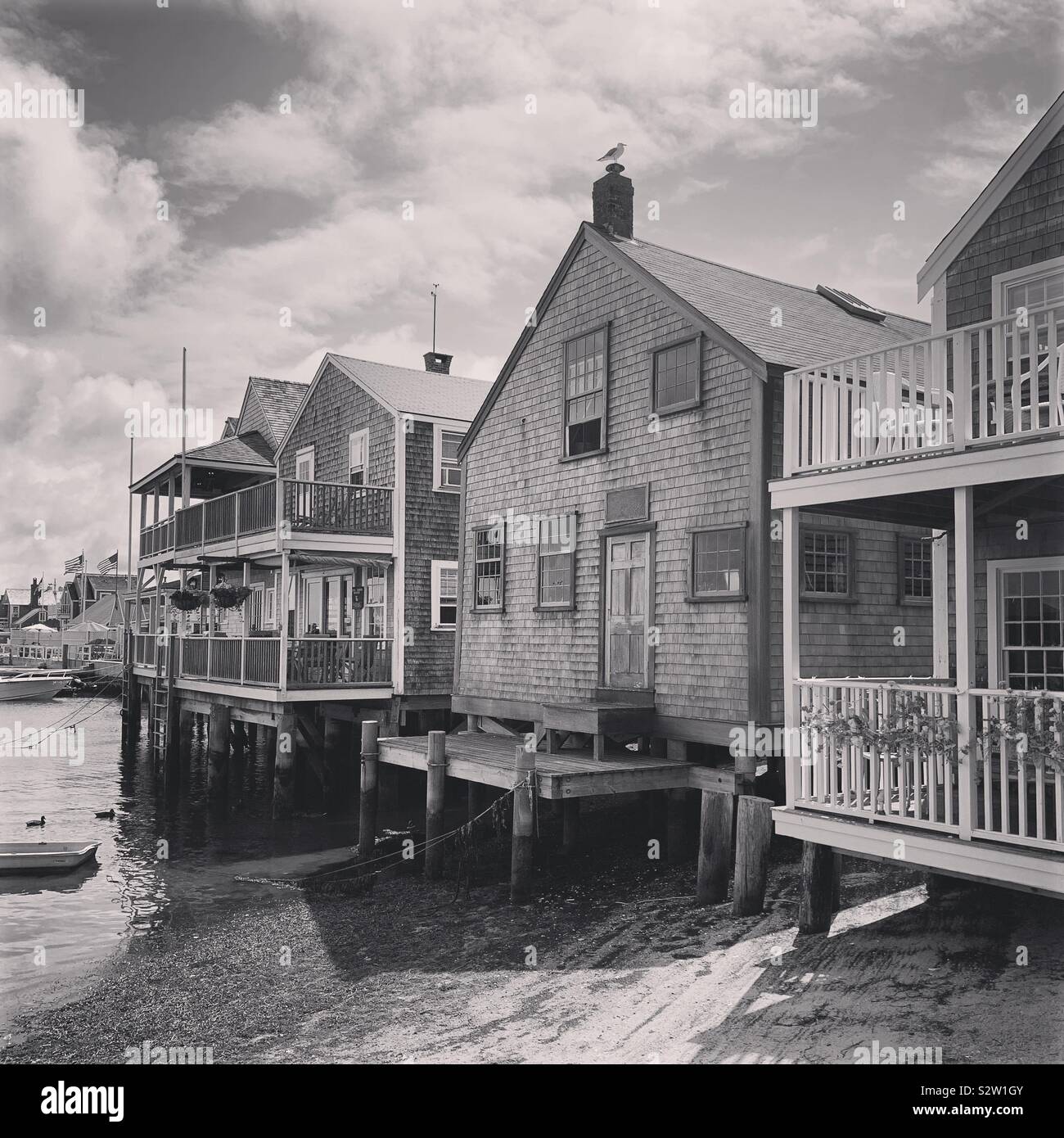 Black and white image of homes over the water on the island of Nantucket, Massachusetts, United States Stock Photo