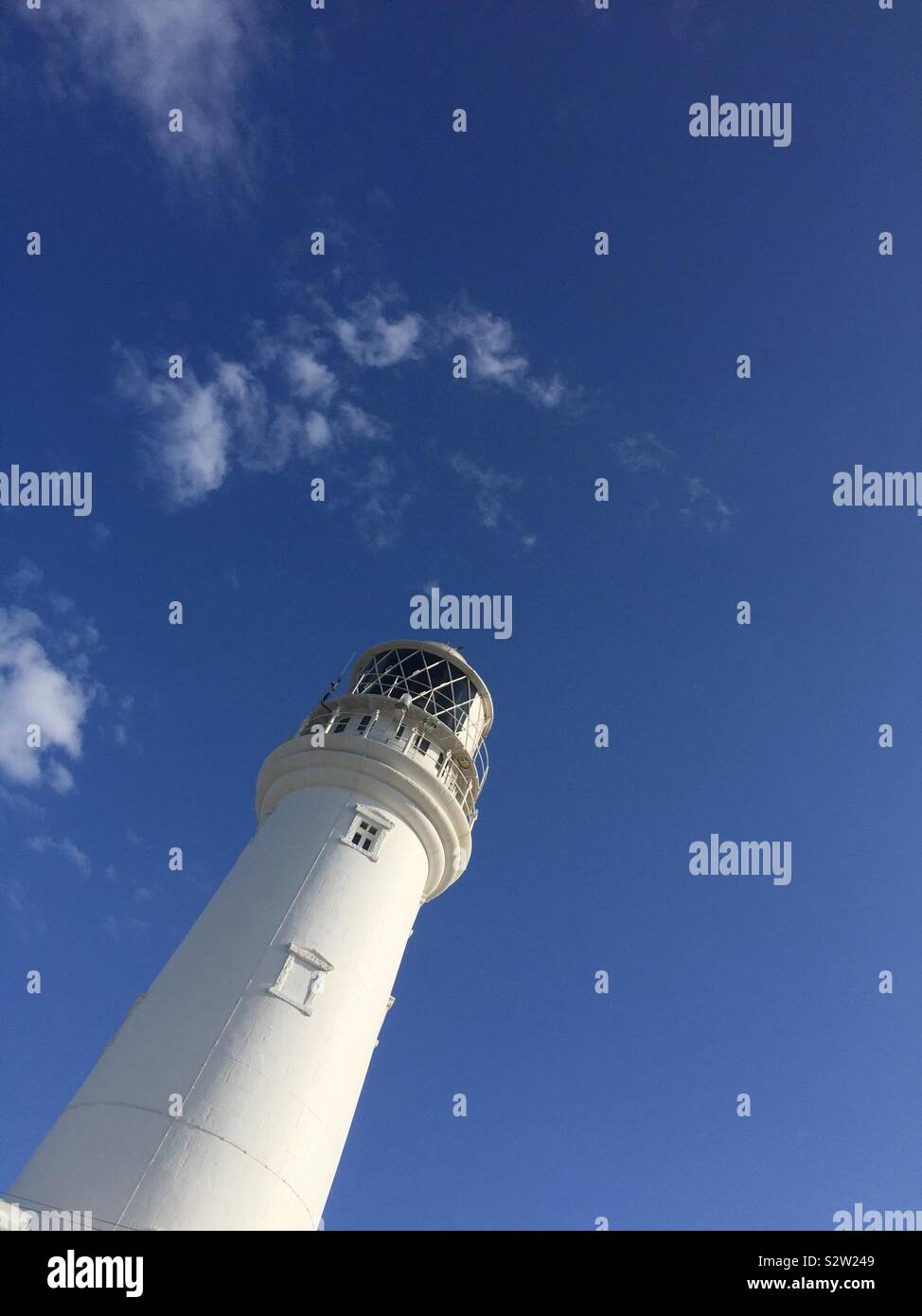 Flamborough Head lighthouse set against a blue sky. - Smartphone Captured Stock Image