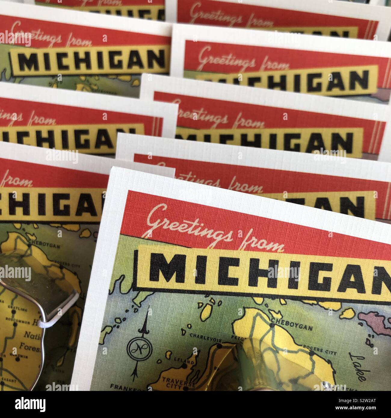 A closeup view of cards that say “greetings from Michigan” aligned on display in a store Stock Photo