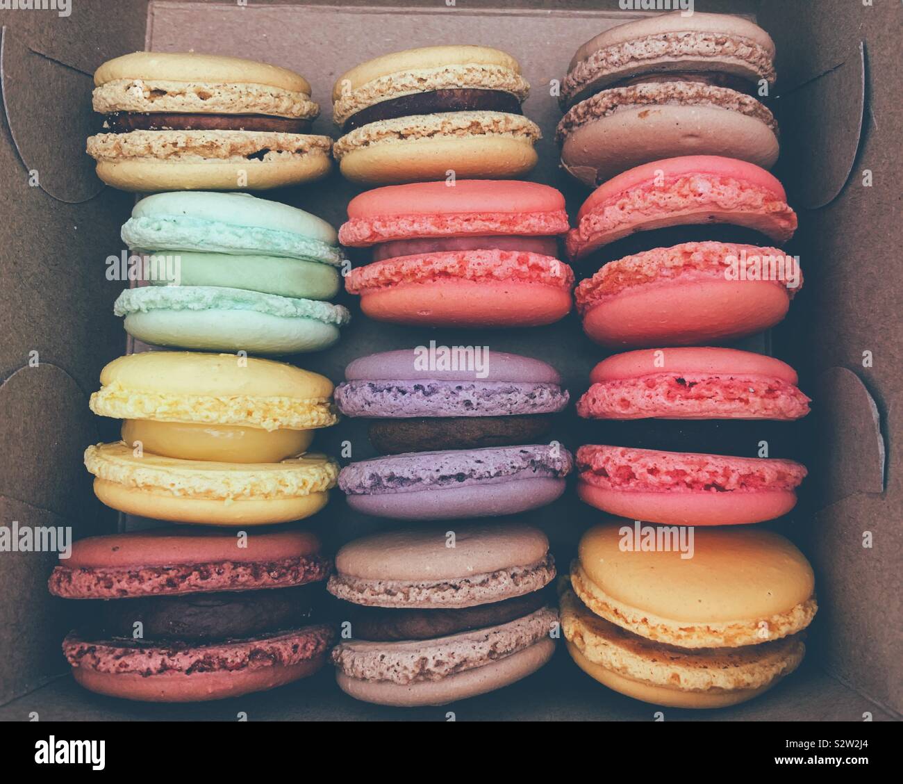 Assortment colourful fresh macarons in a paper box. Stock Photo