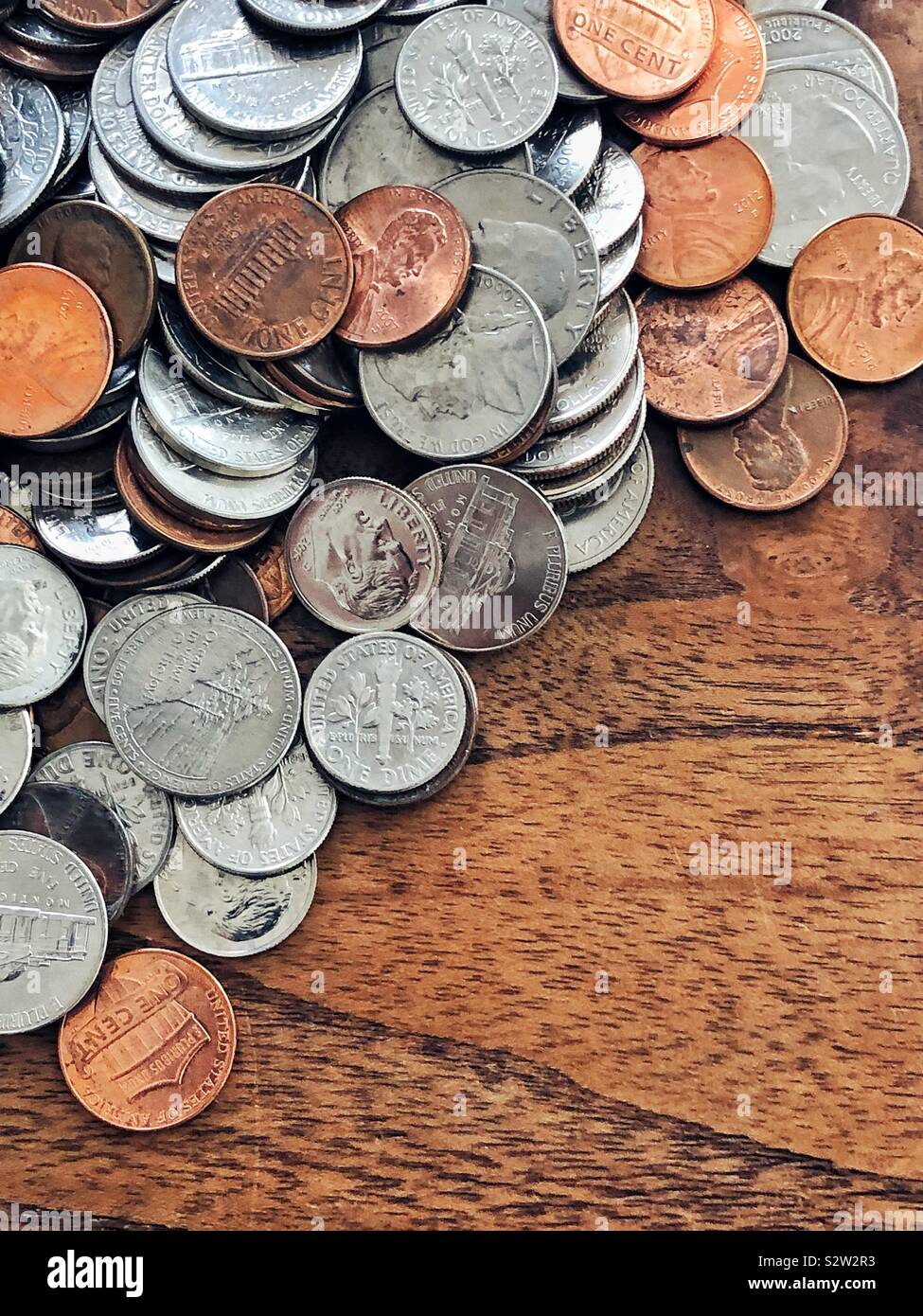 Pile of American coins on wooden table - Smartphone Captured Stock Image