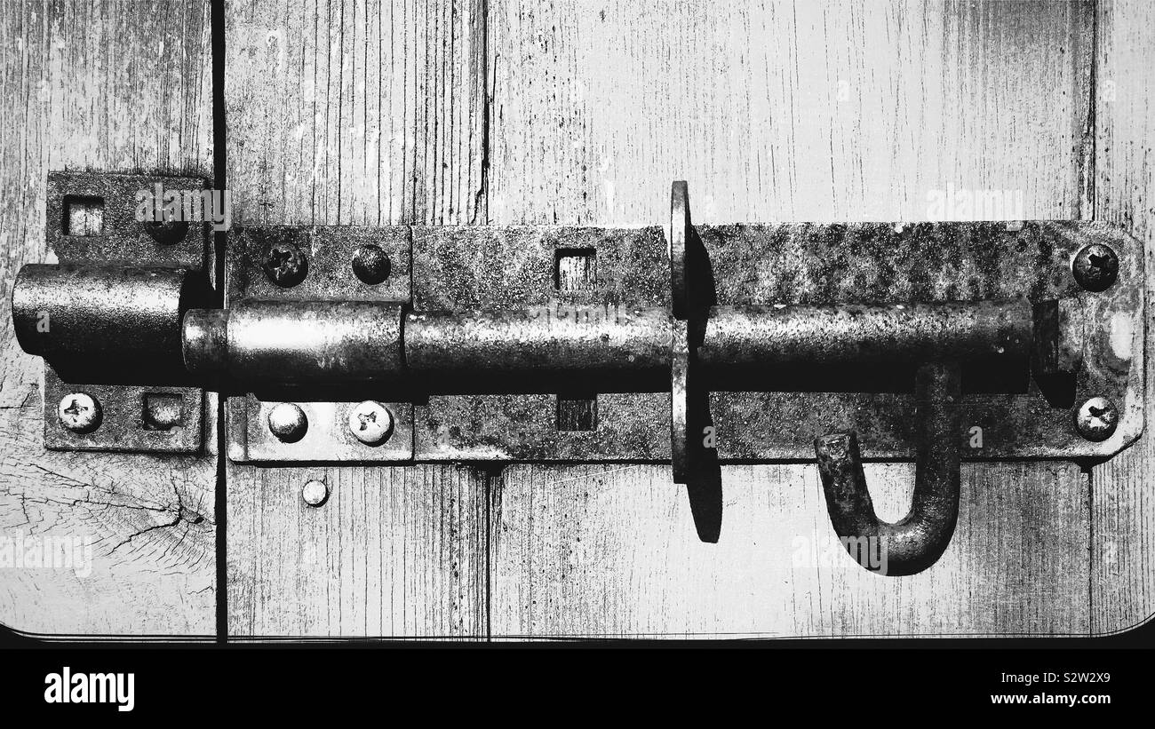 Rusty lock on wooden shed doors Stock Photo