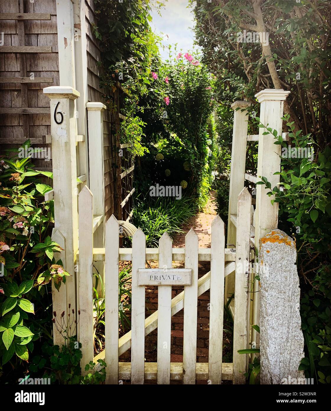 Gate with a “private” sign in front of a garden in the town of Siasconset, Nantucket Island, Massachusetts, United States - Smartphone Captured Stock Image