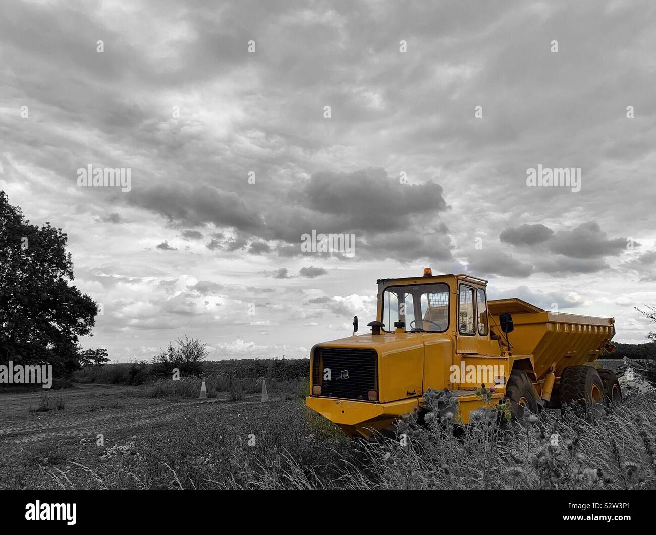 Selective Edit Of A Yellow Dump Truck Against A Black White