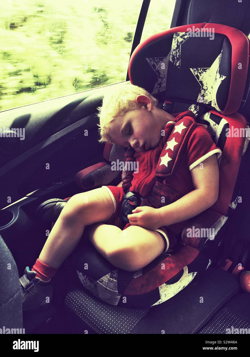 Two year old boy sleeping in the car - Smartphone Captured Stock Image