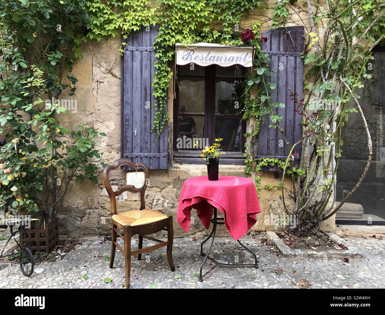Table for one outside French restaurant - Smartphone Captured Stock Image