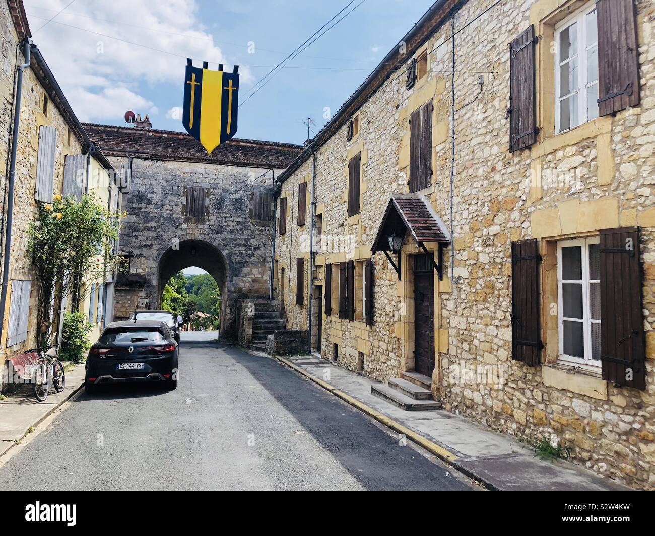 Street and arched entrance in the medieval town of Monpazier in France - Smartphone Captured Stock Image