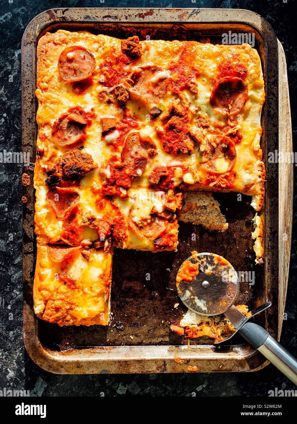 Square pepperoni pizza cut in squares Stock Photo