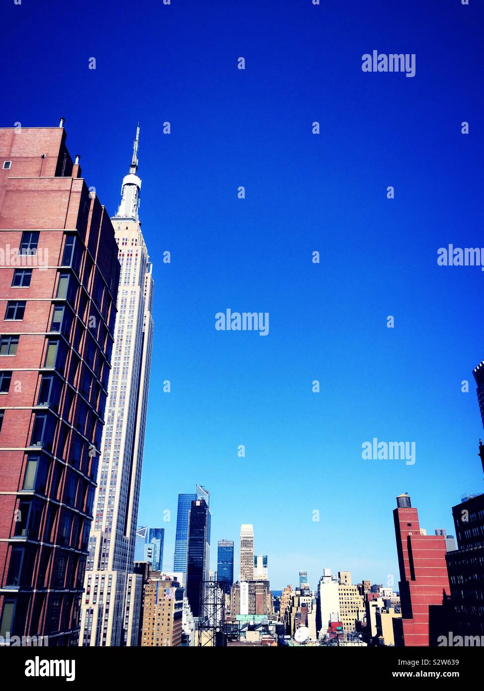 View of Midtown Manhattan skyscrapers including the empire state building from a roof deck in Murray Hill, NYC, USA - Smartphone Captured Stock Image